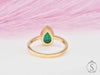 Pear cut green emerald solitaire bezel ring back view