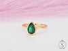 Pear cut green emerald solitaire bezel ring front view